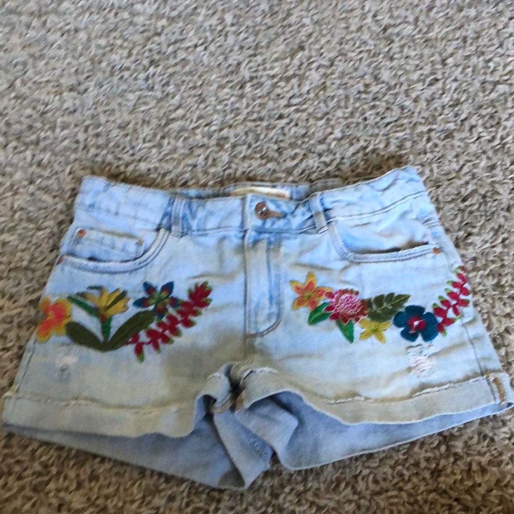 light wash cuffed and slightly distressed embroidered shorts